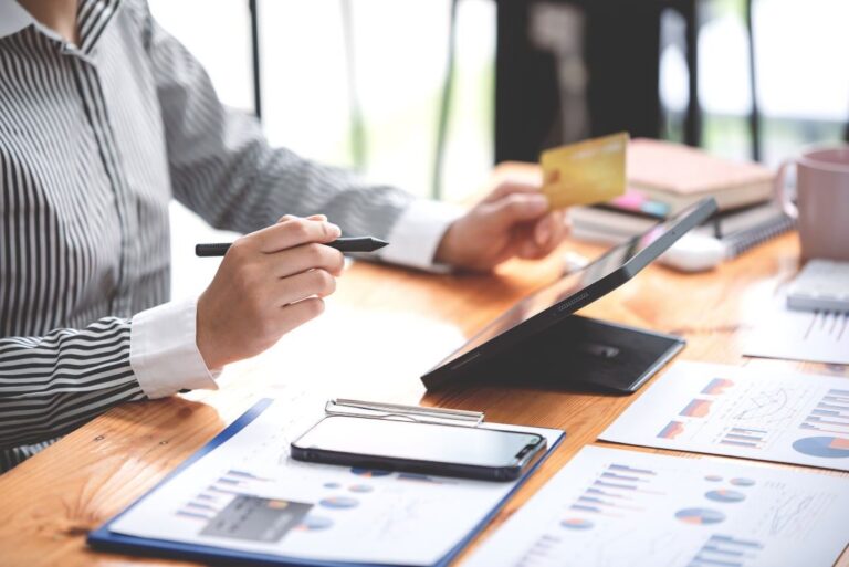 FeatureImage_Young_Woman_Holding_Credit_Card_and_Using_a_Laptop.jpg