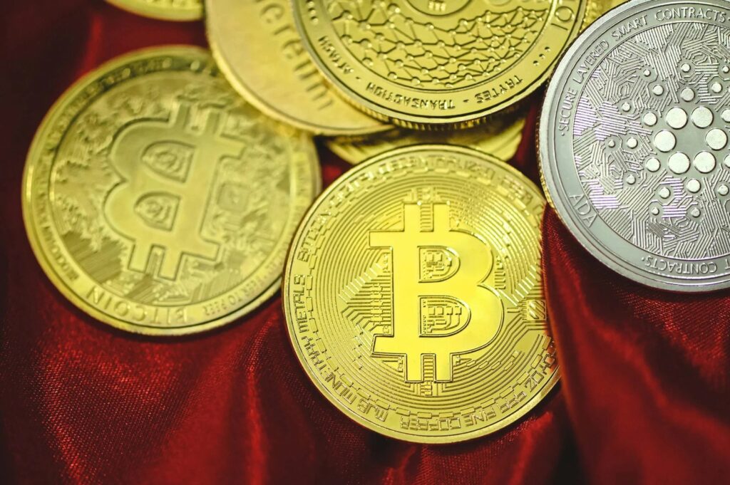 a-pile-of-bitcoins-sitting-on-top-of-a-red-cloth-scaled.jpg